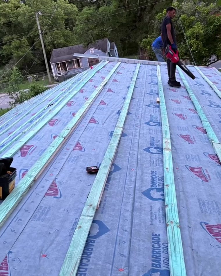 A JaxWood crew member working on an exterior tear-off in Jacksonville
